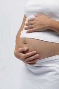 pregnant woman touching her belly